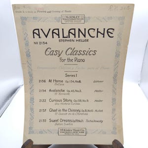 May include: Vintage sheet music titled "Avalanche" by Stephen Heller, part of the "Easy Classics For the Piano" series. The cover is cream-colored with black text and decorative borders. Published by McKinley Music Co.