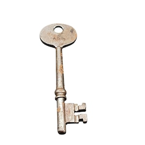 May include: An antique metal key with a circular head and a long, textured stem. The key has a worn, aged appearance with visible rust and the number "A 56" stamped on the head. The bit of the key has a rectangular shape with two teeth.