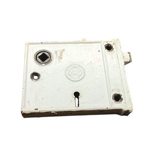 May include: A vintage white metal door lock with a keyhole and several screw holes. The lock has a rectangular shape with rounded edges and a circular emblem in the center. The lock is likely an antique.