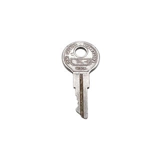 May include: A silver-toned metal key with a round head featuring the embossed text CURTIS IND, EASTLAKE O, U.S.A., and SL-1. The key has a central vertical groove and a jagged edge profile, showing signs of age and metallic wear.