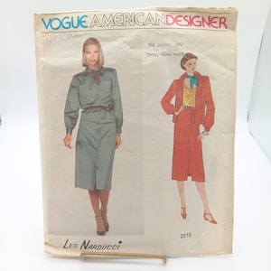 May include: Vintage Vogue American Designer sewing pattern featuring designs by Leo Narducci. The pattern includes illustrations of two outfits: a button-down shirt and skirt set, and a jacket and skirt ensemble. The pattern is labeled "2215".