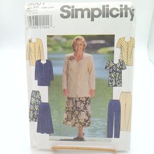 May include: Simplicity sewing pattern for women's clothing, featuring a beige jacket with a floral skirt, a blue jacket with a blue skirt, a beige blouse with polka dots, a blue blouse with floral print, and beige pants with blue pants. The pattern number is 9363.