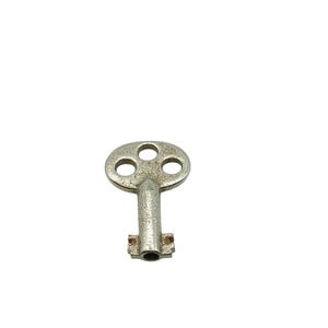 May include: A vintage, silver-colored skeleton key with a circular head featuring three holes. The key has a textured, aged appearance, suggesting it is antique. The key's stem leads to a rectangular bit with a central hole.