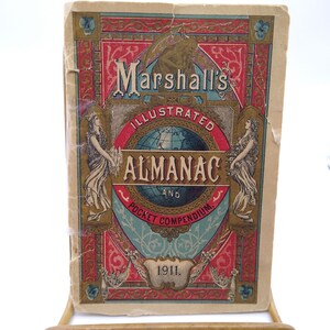 May include: A vintage illustrated almanac and pocket compendium from 1911. The cover features a red, white, and blue design with a globe, ornate lettering, and the title "Marshall's Illustrated Almanac and Pocket Compendium".