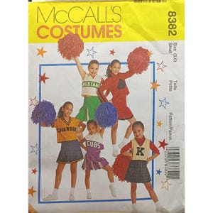 May include: A sewing pattern for five cheerleading costumes for girls. The pattern is for sizes 5 and 6, and is for a petite frame. The pattern is from McCall's Costumes and the pattern number is 8382.