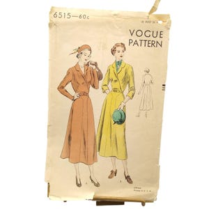 May include: A vintage Vogue Pattern envelope, number 6515, featuring illustrations of two dresses. One dress is orange with long sleeves and a matching hat, while the other is yellow with three-quarter sleeves and a green hat. Text includes 6515-60c.