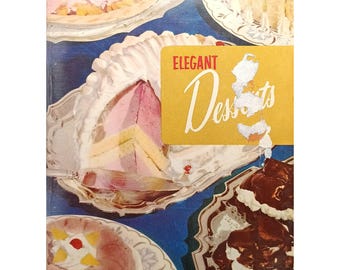 May include: A vintage cookbook cover showcasing various desserts on silver platters. The cover displays the text "220 deliciously distinctive desserts" and a yellow label reading "Elegant Desserts". The image includes layered cakes and other sweet treats.