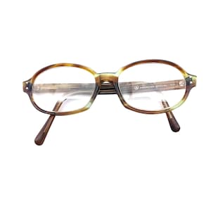 May include: Tortoise shell eyeglasses with clear lenses and the text "AMERICAN OPTICAL 51/17" on the right temple.