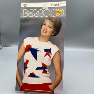 May include: A knitting pattern for a sleeveless sweater with a geometric design in red, white, and blue. The pattern is from Berroco and is called "Glacé".