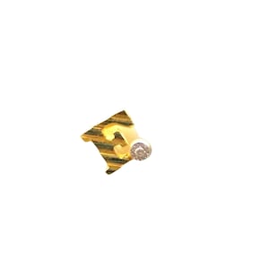 May include: Gold earring with a diamond-shaped design featuring the number "3" and a small diamond accent.