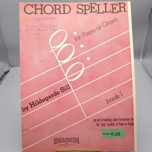 May include: A vintage music book titled "Chord Speller" by Hildegarde Sill. The cover is pink with white musical notes and diagonal lines. The text includes "for Piano or Organ" and "book-1". There is a handwritten inscription and a price tag.