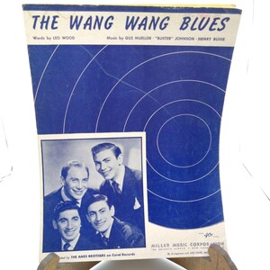 May include: Vintage sheet music titled "The Wang Wang Blues" with text by Leo Wood and music by Gus Mueller, Buster Johnson, and Henry Busse. The cover is blue with white circular lines and features a black and white photo of The Ames Brothers.