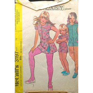 May include: Vintage McCall's pattern 3197 for a child's jumpsuit and reversible wrap skirt. The illustration shows three girls in outfits with a pink and white checkered pattern. The pattern includes the size 12 and the price.