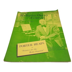 May include: A vintage green pamphlet titled The Hammond Organ Company presents Porter Heaps in Pointers for the Home Organist. The cover features a black and white photograph of a man in a suit and bowtie sitting at an organ, with text details.