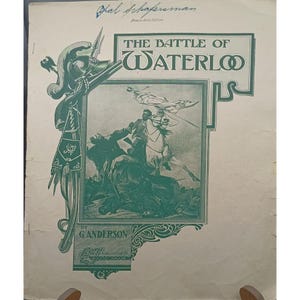 May include: Vintage sheet music cover titled "The Battle of Waterloo" in green and white. The cover features an illustration of a battle scene with soldiers on horseback and a decorative border. The text includes the name "G. Anderson" and the publisher.