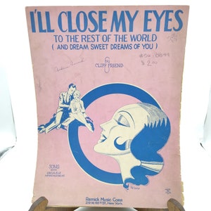 May include: A vintage sheet music cover with a pink background and blue accents. The title is "I'll Close My Eyes To The Rest Of The World (And Dream Sweet Dreams Of You)" by Cliff Friend. The cover features a woman with her eyes closed and a couple in the background.