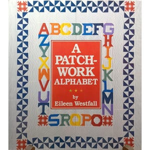 Puede incluir: Un edredón de alfabeto de patchwork con un fondo blanco y letras coloridas. El edredón presenta un rectángulo rojo con el texto "A Patchwork Alphabet" de Eileen Westfall. El borde tiene patrones geométricos azules y rojos.