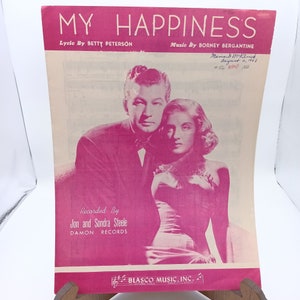 May include: A vintage sheet music cover for the song "My Happiness" by Betty Peterson and Borney Bergantine. The cover features a black and white photo of a couple in a romantic embrace. The text "Recorded By Jon and Sondra Steele Damon Records" is printed below the photo.