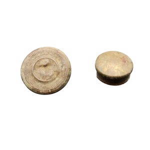 May include: Two antique bottle stoppers. One is a round, light brown stopper with a detailed circular design. The other is a smaller, rounded stopper with a gold-toned finish. Both stoppers are isolated on a white background.