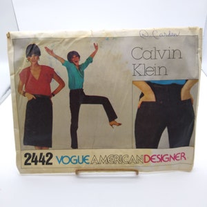 May include: A vintage sewing pattern for a pair of pants by Calvin Klein. The pattern is from Vogue American Designer and has the number 2442 printed on it.