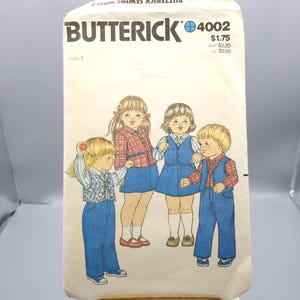 May include: Vintage Butterick 4002 sewing pattern featuring illustrations of children in various outfits. The pattern includes drawings of children wearing denim pants, vests, and dresses. The pattern's cover is cream-colored with the Butterick logo and price.