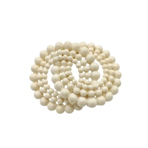 May include: A set of white beaded bracelets, arranged in a circular pattern. The beads are all different sizes and shapes, creating a unique and textured look.