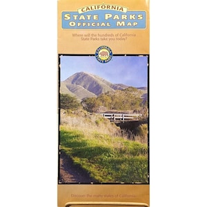May include: A California State Parks Official Map. The map features a scenic landscape with a mountain, bridge, and grassy area. The text on the map reads "Where will the hundreds of California State Parks take you today?" and "Discover the many states of California."