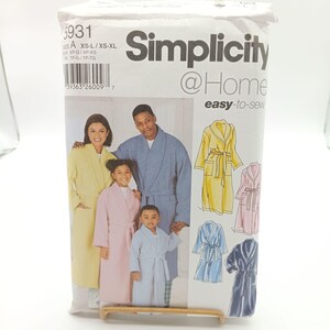 May include: Simplicity @Home easy-to-sew sewing pattern for robes. The pattern includes four different robe designs in blue, yellow, pink, and navy. The pattern is for sizes XS-L/XS-XL.