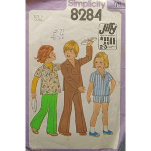 May include: Simplicity pattern 8284 for children's clothing. The pattern features illustrations of three children wearing different outfits: a floral shirt with green pants, a brown suit, and a striped shirt and shorts set. The pattern is for size 4.