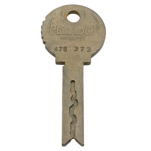 May include: A vintage metal key with the text "BELL LOCK PATENTED" and the numbers "47S-373" stamped on the circular head. The key has a unique, intricate pattern cut into the shaft, and a small hole at the top. The key is a dull silver color.