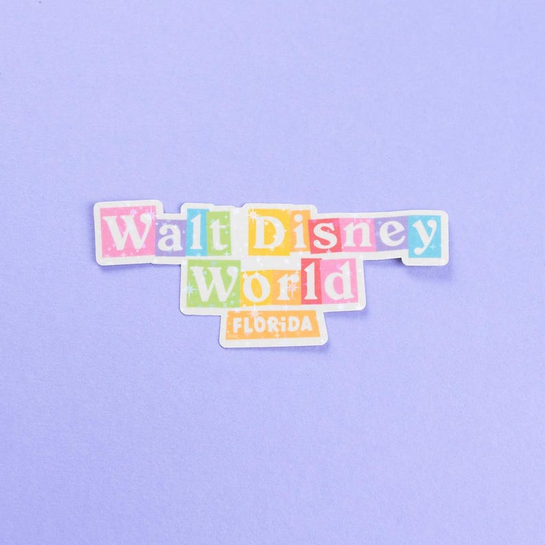 May include: A colorful sticker with the text "Walt Disney World" in a retro font. The words are in individual boxes with different colors. The text "Florida" is in a smaller box below the main text.