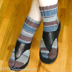 May include: A pair of striped socks with brown, blue and grey stripes are worn with black thong sandals. The socks are pulled up to the calf.