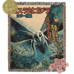May include: A woven cotton throw blanket featuring a vintage-style illustration of a giant moth with Japanese text. The artwork is in shades of blue, green, and brown, with the words "100% Cotton" and "Ultra Soft & Cozy" on the blanket.