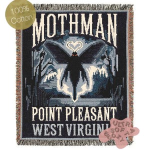 May include: A black and blue woven tapestry with the text "Mothman Point Pleasant West Virginia" and an image of a moth with red eyes. The tapestry has a fringe border and a tag that says "100% Cotton Ultra Soft & Cozy".