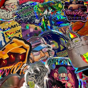 May include: A collection of holographic stickers with various designs. The stickers feature images of Santa Claus, cartoon characters, a skull, and text including "TWIZTED TREE" and "Purple Punch". The stickers have a shiny, iridescent finish.