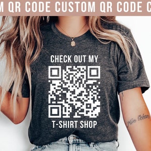 May include: A dark grey heather t-shirt with a white QR code and the text "CHECK OUT MY T-SHIRT SHOP".