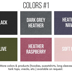 May include: A chart showing different color options for clothing. The colors include black, dark grey heather, heather navy, olive, heather raspberry, and soft pink. The text "COLORS #1" is at the top of the chart.