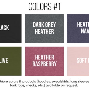 May include: A chart showing different color options for clothing. The colors include black, dark grey heather, heather navy, olive, heather raspberry, and soft pink. The text "COLORS #1" is at the top of the chart.