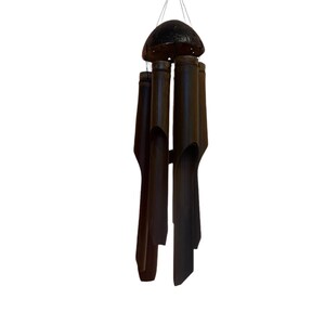 May include: A brown bamboo wind chime with a round, dark brown top. The chime has five tubes of varying lengths.