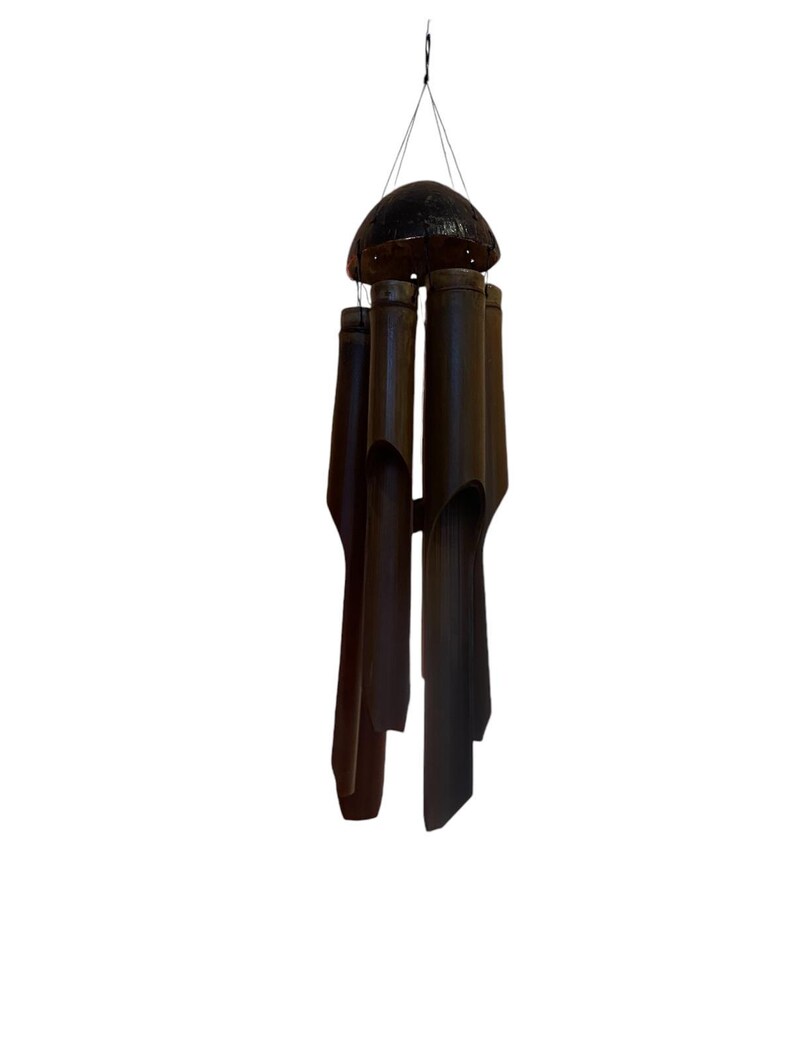 May include: A brown bamboo wind chime with a round, dark brown top. The chime has five tubes of varying lengths.