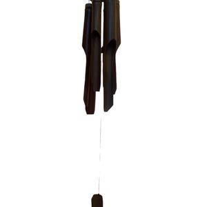 May include: A black bamboo wind chime with a wooden top and a long string hanging from it.