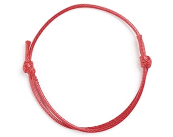 May include: A red string bracelet with two knots on either end.