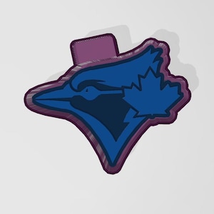 May include: A blue and white baseball team logo with a bird and a maple leaf. The logo is outlined in purple.