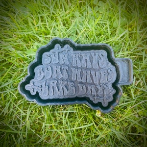 May include: A black 3D printed mold with the text "Sun Rays, Boat Waves, Lake Days" in a retro font.