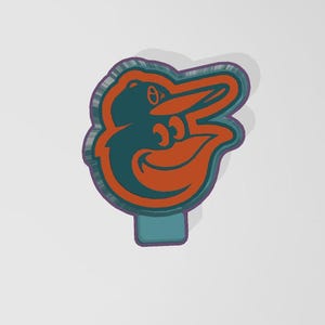 May include: A teal blue and orange cookie cutter shaped like the Baltimore Orioles mascot, a cartoon bird with a baseball cap.