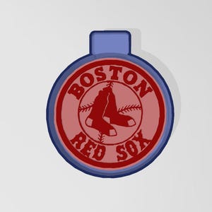 May include: Red and blue circular cookie cutter with the words "Boston Red Sox" and a baseball with crossed bats and two red socks.