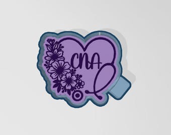 May include: A purple heart-shaped design with the letters "CNA" and a stethoscope. The heart is adorned with floral elements on the left side. The design has a blue outline and a small blue rectangle on the bottom right.
