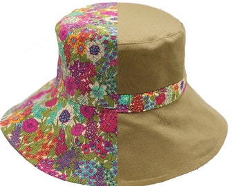 May include: A bucket hat featuring a split design with one half in solid tan and the other half in a vibrant floral pattern of pink, blue, orange, and green flowers. A matching floral band encircles the tan section. The text BUCKETOFJOY.com.au is visible.