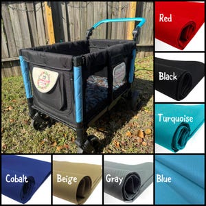 May include: A black wagon with a blue handle and blue trim. The wagon has a black fabric interior and a mesh window. The wagon is sitting on a green lawn. The image also shows swatches of fabric in various colours, including red, black, turquoise, cobalt, beige, grey, and blue.