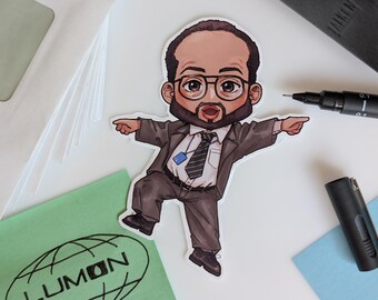 May include: A sticker depicting a cartoon man in a suit, glasses, and a beard, pointing with both hands. The sticker is on a white surface with a green square with the word "LUMON" and a black pen.